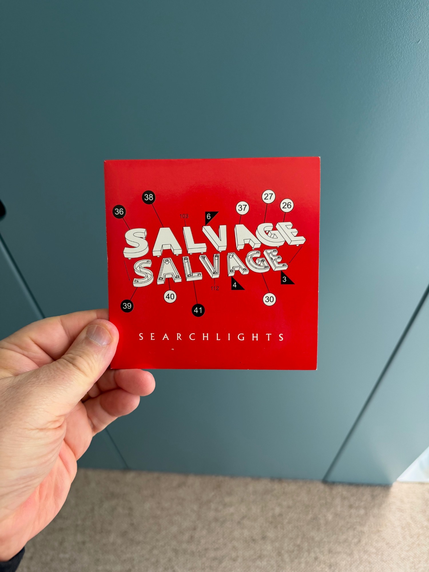 Front of the Salvage 'Searchlights' CD single slipcase: the band name twice in white block letters on red, above the title